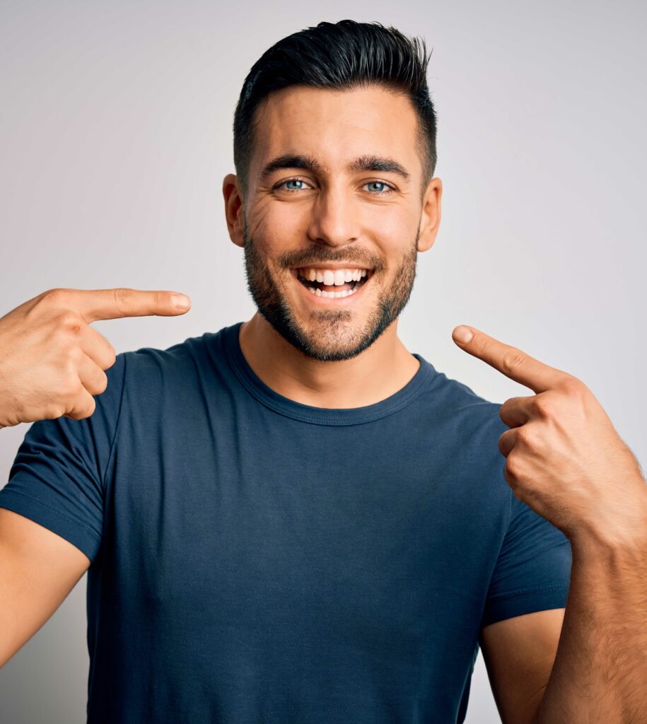 man pointing to teeth